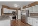 Well-lit kitchen with stainless steel appliances and white cabinetry at 3821 W Barcelona Dr, Chandler, AZ 85226