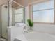 Inviting bathroom featuring a soaking tub, separate shower, and bright window, offering a spa-like experience at 41280 W Sanders Way, Maricopa, AZ 85138