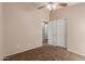 A bright bedroom with a double closet, neutral paint, and a connecting door to the bathroom at 41280 W Sanders Way, Maricopa, AZ 85138