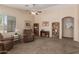 Spacious living room with a comfortable seating area and bookcases at 41280 W Sanders Way, Maricopa, AZ 85138