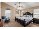 Spacious bedroom with vaulted ceilings, ceiling fan, and a large bed, offering comfort and relaxation at 41280 W Sanders Way, Maricopa, AZ 85138