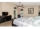 Comfortable bedroom with a ceiling fan, soft lighting, and neutral colors, creating a relaxing retreat at 41280 W Sanders Way, Maricopa, AZ 85138