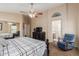 Bright bedroom featuring vaulted ceiling, ceiling fan, and views to ensuite bathroom and walk-in closet at 41280 W Sanders Way, Maricopa, AZ 85138
