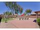 Landscaped backyard with pool, waterfall feature, tanning ledge, and lounge chairs at 42812 W Venture Rd, Maricopa, AZ 85138