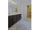 Bright bathroom boasts a double vanity, stylish tile floors, and an adjacent closet, perfect for convenience at 42812 W Venture Rd, Maricopa, AZ 85138