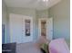 Comfortable bedroom featuring a closet with mirrored doors, a ceiling fan, and an open doorway at 42812 W Venture Rd, Maricopa, AZ 85138