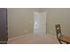 View of a carpeted bedroom with neutral walls, with a chair and doorway to another room at 42812 W Venture Rd, Maricopa, AZ 85138