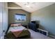 Cozy bedroom featuring vaulted ceilings, a neutral color palette, and a window with neighborhood views at 42812 W Venture Rd, Maricopa, AZ 85138