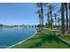 Beautiful lake with fountains and palm trees, surrounded by green spaces for community enjoyment at 42812 W Venture Rd, Maricopa, AZ 85138