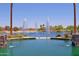 Serene lake with decorative fountains and palm trees, complemented by picturesque landscaping and bench seating at 42812 W Venture Rd, Maricopa, AZ 85138