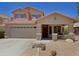 Charming two-story home featuring a covered porch, desert landscaping, and a two car garage at 42812 W Venture Rd, Maricopa, AZ 85138