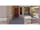 Cozy front porch area with seating and stone accents offers a welcoming entrance at 42812 W Venture Rd, Maricopa, AZ 85138