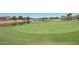 Lush golf course with a tranquil water feature and well-manicured green, ideal for golf enthusiasts at 42812 W Venture Rd, Maricopa, AZ 85138