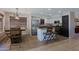 Bright kitchen features stainless steel appliances, island with bar seating, and breakfast nook at 42812 W Venture Rd, Maricopa, AZ 85138