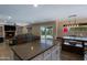 Open kitchen with a large island, seamless transition to the living and dining areas at 42812 W Venture Rd, Maricopa, AZ 85138