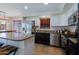 Open kitchen with stainless steel appliances, granite counters, and an adjacent dining area at 42812 W Venture Rd, Maricopa, AZ 85138