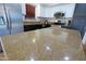 Kitchen island featuring granite counters, stainless appliances, and tile floor at 42812 W Venture Rd, Maricopa, AZ 85138