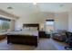 Spacious bedroom boasts a king-size bed, sitting area, and recessed lighting, perfect for relaxation at 42812 W Venture Rd, Maricopa, AZ 85138