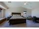 Comfortable bedroom featuring a king-size bed, a desk, and recessed lighting, perfect for unwinding at 42812 W Venture Rd, Maricopa, AZ 85138