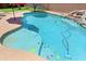Sparkling pool with rock waterfall, tanning ledge, and colorful turtle and fish accents at 42812 W Venture Rd, Maricopa, AZ 85138