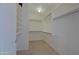 Bright walk-in closet with ample shelving and hanging space for organization and storage at 42812 W Venture Rd, Maricopa, AZ 85138