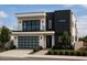 Striking modern two-story home featuring a sleek black and white color scheme, balcony, and an integrated garage at 4422 E Roma Ave, Phoenix, AZ 85018