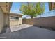Cozy back patio features a privacy wall, gravel landscaping, and views of mature trees at 4752 N 20Th Ave, Phoenix, AZ 85015