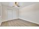 This bedroom features a ceiling fan, neutral paint, wood flooring, and double door closet at 4752 N 20Th Ave, Phoenix, AZ 85015