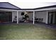 Spacious covered patio in backyard with plenty of seating for entertaining and a view of the grassy yard at 4755 E Gary St, Mesa, AZ 85205