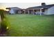 A beautiful home featuring a large, grassy backyard and a covered patio perfect for outdoor entertaining at 4755 E Gary St, Mesa, AZ 85205