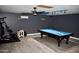Spacious finished basement with a pool table, exercise equipment, and a drop ceiling at 4755 E Gary St, Mesa, AZ 85205