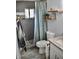 Cozy bathroom featuring a tiled shower with gray accents and wood shelving at 4755 E Gary St, Mesa, AZ 85205