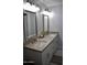 Bathroom vanity features double sinks, framed mirrors, granite countertops and ample storage space at 4755 E Gary St, Mesa, AZ 85205