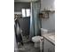 Bathroom with a shower, dark grey tile, stone floor, and neutral decor at 4755 E Gary St, Mesa, AZ 85205