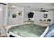 Bright bedroom with rustic white wood furnishings and a mounted television at 4755 E Gary St, Mesa, AZ 85205