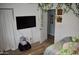 Bright bedroom with wood floors, large screen tv and charming decorations on the walls at 4755 E Gary St, Mesa, AZ 85205