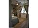 Bright bedroom featuring leafy vines, window, light grey walls, light wood flooring, and modern ceiling fan at 4755 E Gary St, Mesa, AZ 85205