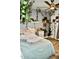 Bright bedroom is adorned with faux vines, plants, a ceiling fan, and a comfortable bed at 4755 E Gary St, Mesa, AZ 85205