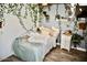 Cozy bedroom features faux vines, plants, and a comfy bed with decorative pillows and a soft blanket at 4755 E Gary St, Mesa, AZ 85205