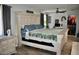 Charming bedroom with a whitewashed wood bed frame, stylish furniture, and neutral tones at 4755 E Gary St, Mesa, AZ 85205