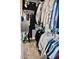 Walk-in closet with visible clothing racks and visible hanging clothes for ample storage at 4755 E Gary St, Mesa, AZ 85205