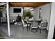 Outdoor entertaining on the covered patio with dining, tv, and lounge seating at 4755 E Gary St, Mesa, AZ 85205