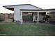 Enjoy outdoor living with this covered patio including a TV, and comfortable seating at 4755 E Gary St, Mesa, AZ 85205