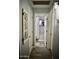 Hallway featuring doors leading to a bathroom, wood-look flooring, and neutral paint at 4755 E Gary St, Mesa, AZ 85205