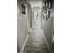 Hallway featuring doors leading to rooms and bathrooms, wood-look flooring, and neutral paint at 4755 E Gary St, Mesa, AZ 85205