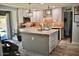 Bright kitchen features a center island, stainless steel appliances, and sliding glass door leading to the backyard at 4755 E Gary St, Mesa, AZ 85205