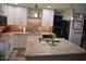 Well-lit kitchen featuring granite countertops, modern appliances, and a center island with stylish pendant lighting at 4755 E Gary St, Mesa, AZ 85205