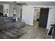 Open living room with plank floors and sliding barn door for a touch of rustic charm at 4755 E Gary St, Mesa, AZ 85205