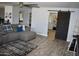 Open-concept living room features a gray sectional sofa, barn door, and stylish decor at 4755 E Gary St, Mesa, AZ 85205