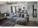 Spacious living room with a large sectional, stylish rug, and open access to the dining area at 4755 E Gary St, Mesa, AZ 85205